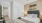  A bedroom with a large bed and a painting of sheep on the wall.