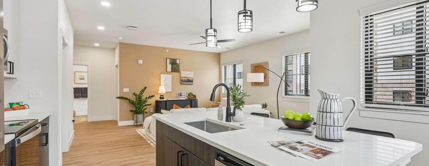 Kitchen and living room at Solace at the Ranch apartments in Colorado Springs.