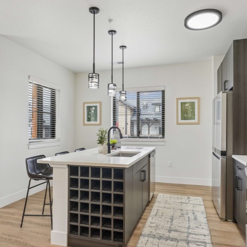 Modern kitchen with island at Solace at the Ranch apartments for rent in Colorado Springs.