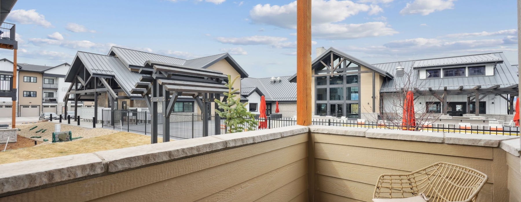Patio with chair overlooking the clubhouse at Solace at the Ranch apartments in north Colorado Springs.